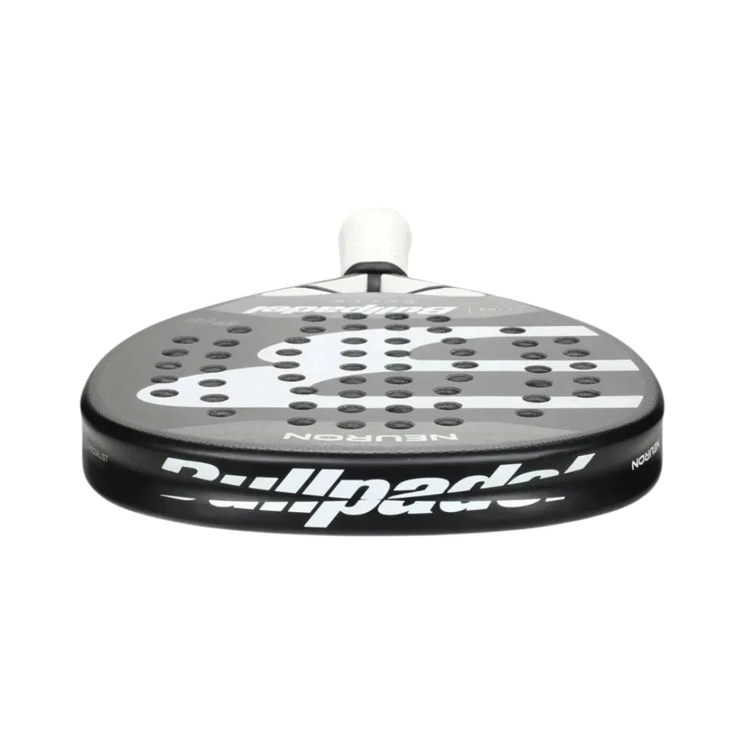 Close-up view of the BullPadel Padel Racket Neuron 2024 Fede Chingotto, featuring a black and white design with perforations and rounded edges. It has a light grip on the handle, Vibradrive for comfort, and is built with Xtend Carbon 3K for enhanced performance.