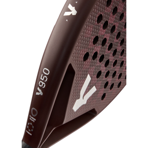 Close-up of the maroon VOLT 950 V23 padel racket by Volt, designed for advanced players. It features a hexagonal grid pattern and a handle with small white logos. Crafted for power and control, its matte surface displays a refined carbon texture.